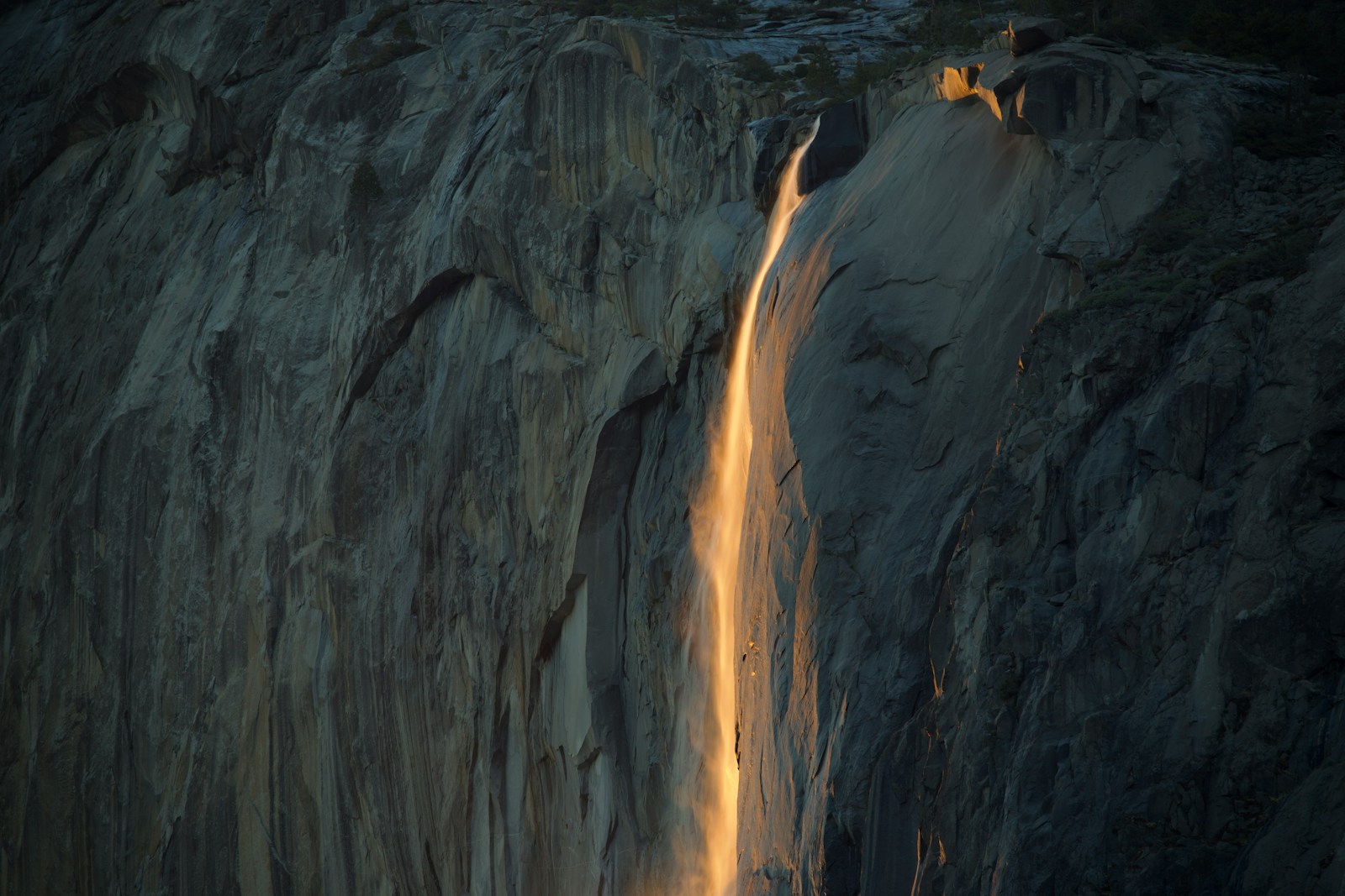 A waterfall with light breaking through it