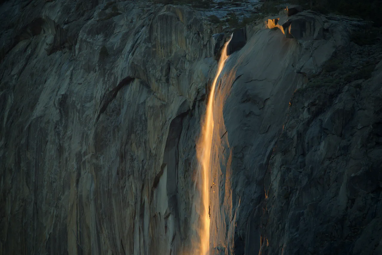 A waterfall with light breaking through it